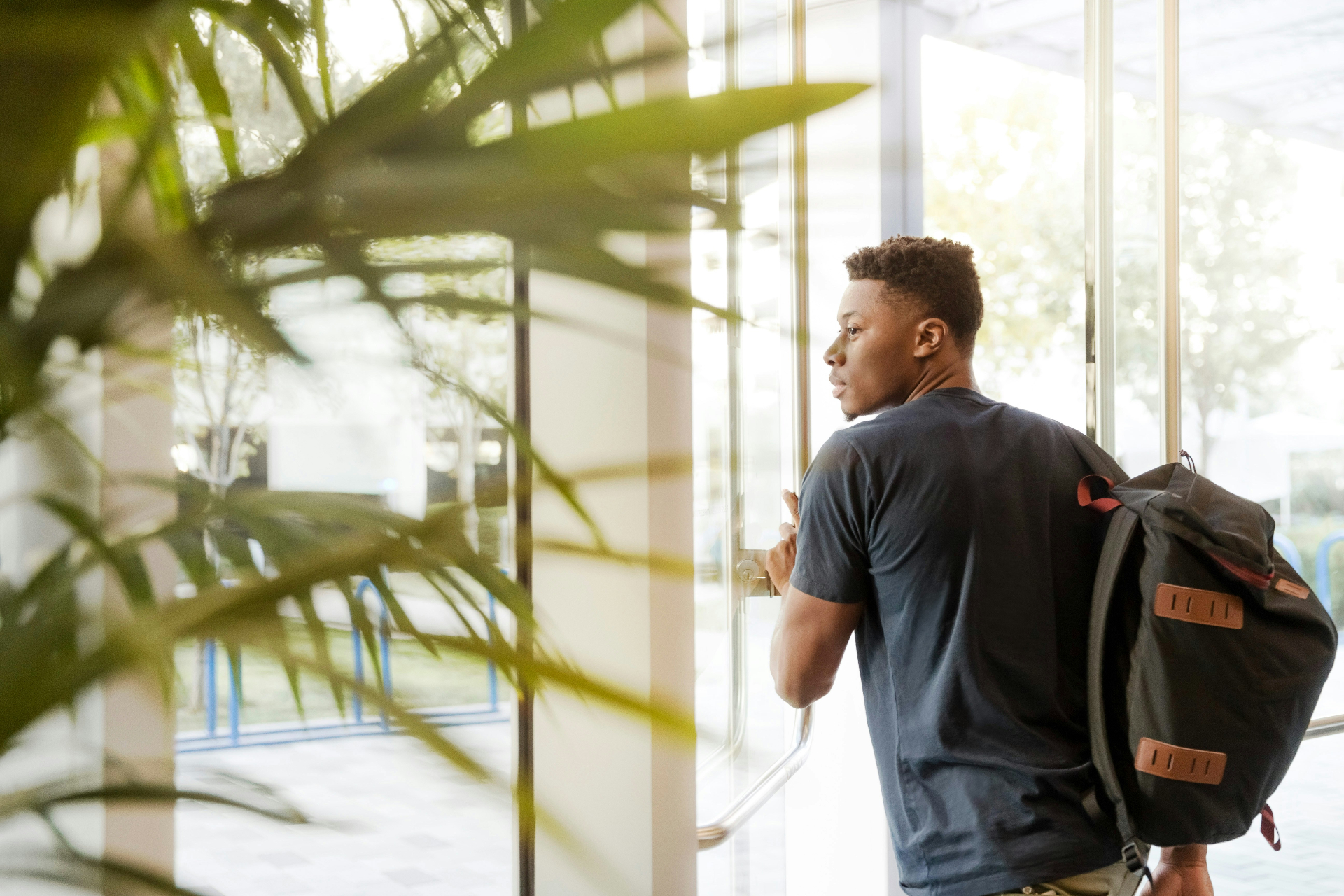 Student with a backpack heading into a university building