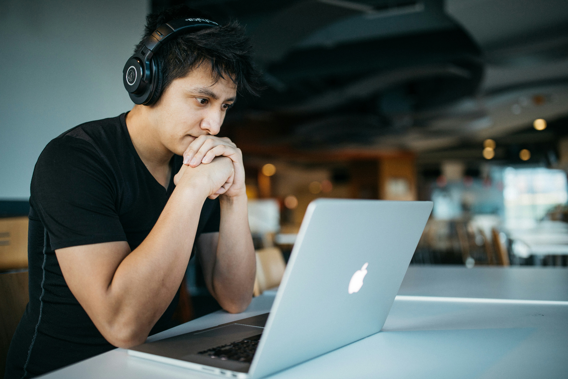 Student wearing headphones studying on a laptop